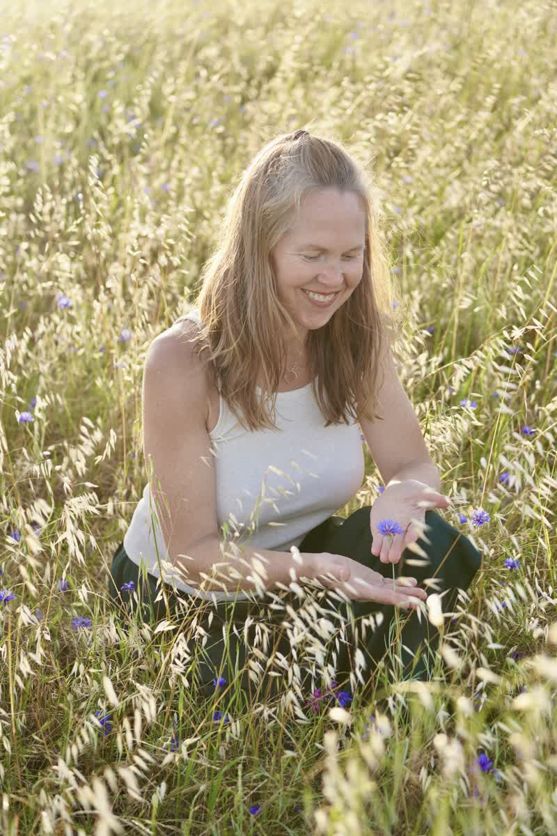 A grounding somatic co-regulation practice in the grass.